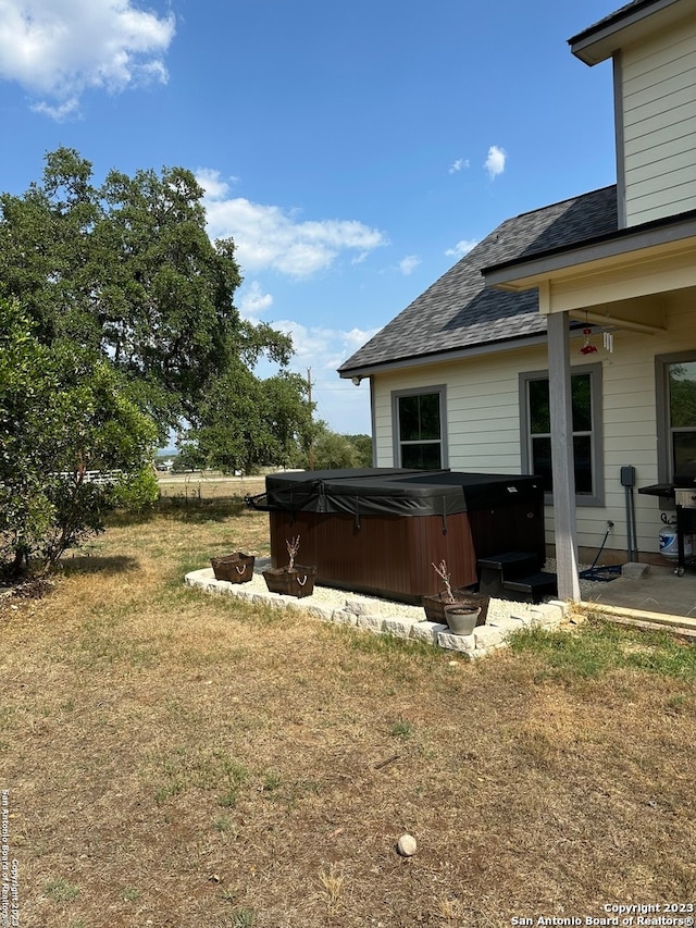 view of yard featuring a patio area and a hot tub