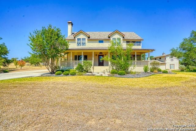 view of front of home featuring a front lawn and a porch