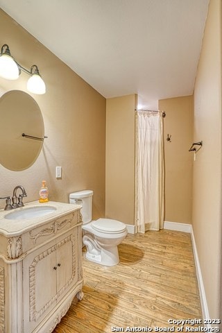 bathroom featuring hardwood / wood-style floors, toilet, and large vanity