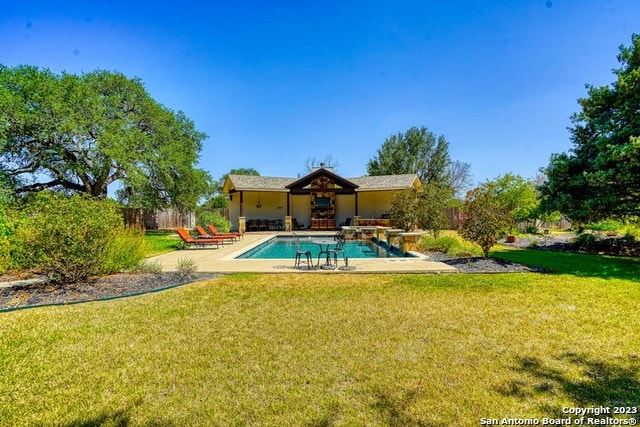 view of pool featuring a patio and a lawn