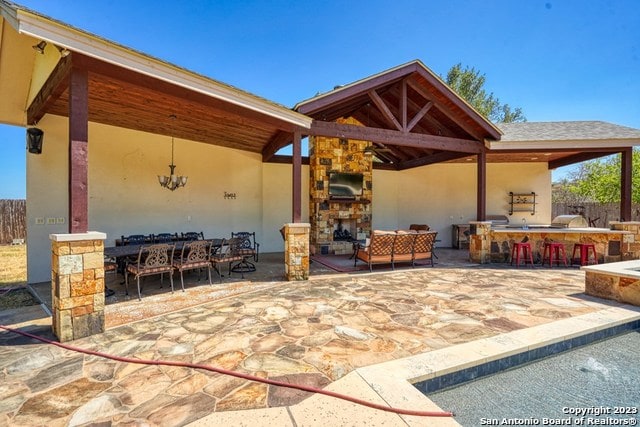 view of patio featuring an outdoor bar and a gazebo