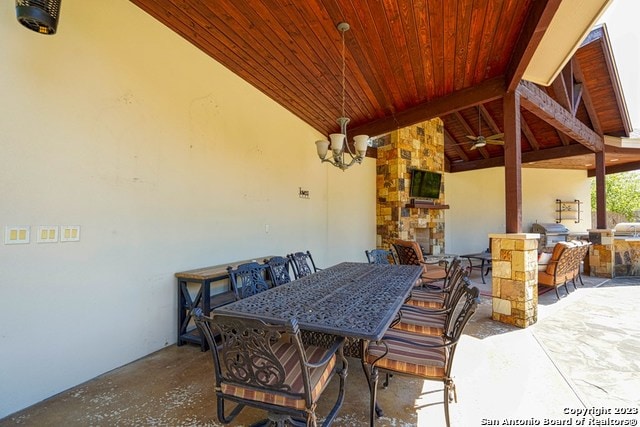 view of patio with a grill and a fireplace