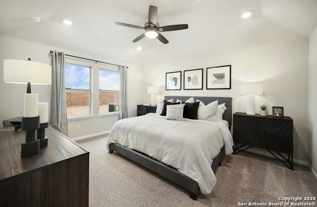 bedroom featuring carpet flooring, vaulted ceiling, and ceiling fan