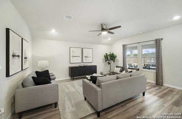 living room featuring ceiling fan and light hardwood / wood-style floors