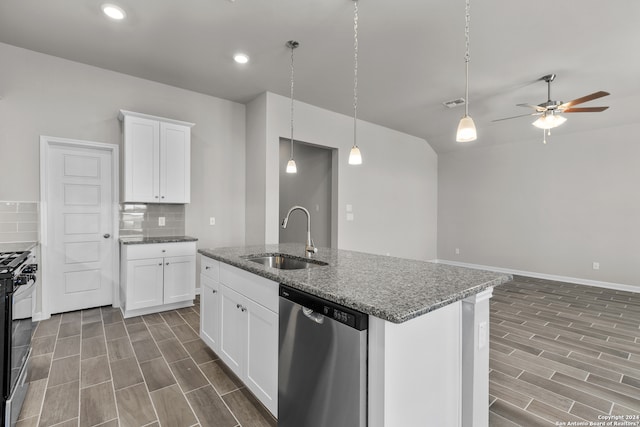 kitchen with appliances with stainless steel finishes, sink, ceiling fan, white cabinetry, and tasteful backsplash