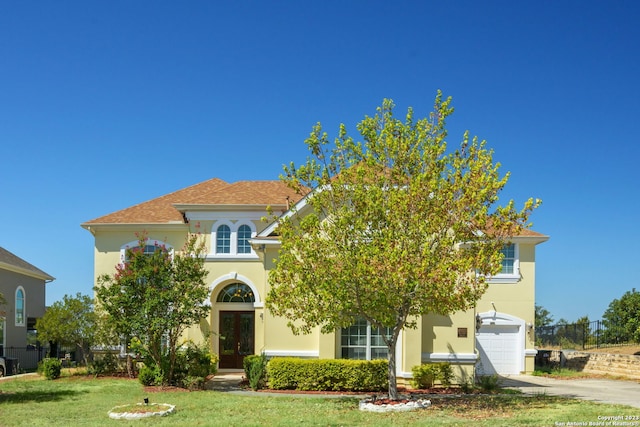 view of front of property with a front lawn and a garage