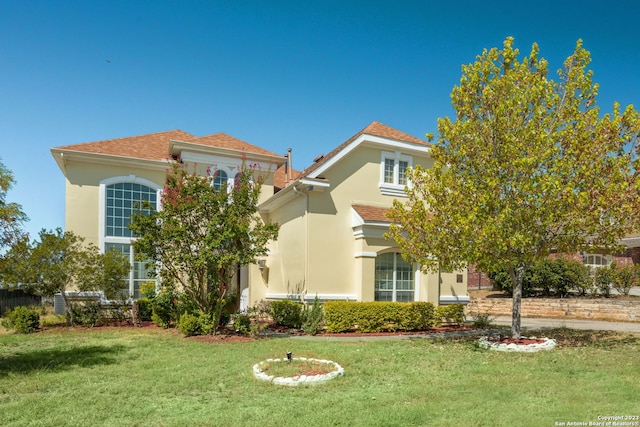 mediterranean / spanish-style house featuring a front lawn