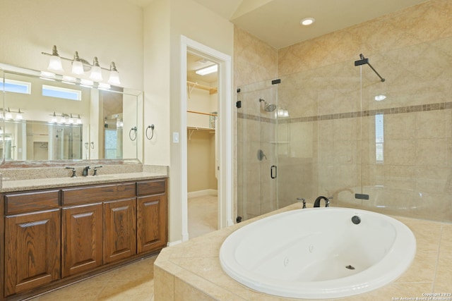 bathroom featuring oversized vanity, shower with separate bathtub, and tile floors