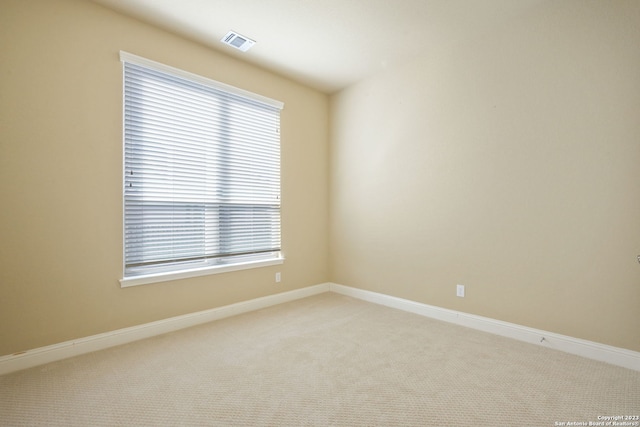 empty room with light carpet and a wealth of natural light