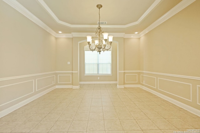 unfurnished room with light tile floors, a notable chandelier, a tray ceiling, and ornamental molding