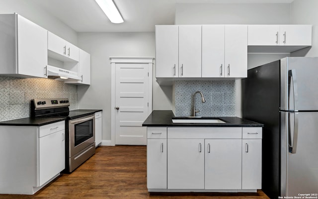 kitchen with dark hardwood / wood-style flooring, white cabinetry, stainless steel appliances, backsplash, and sink