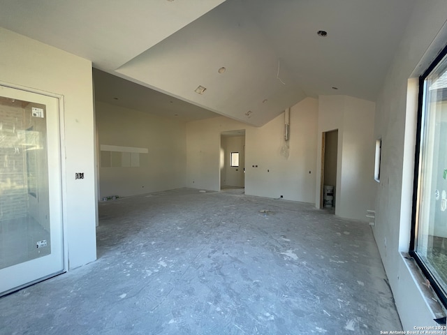 unfurnished room featuring lofted ceiling