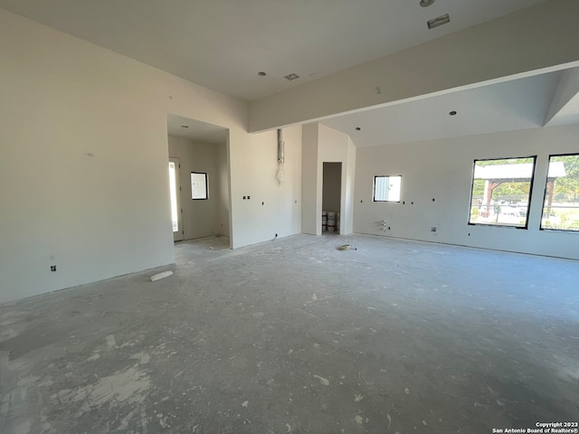 unfurnished living room with lofted ceiling