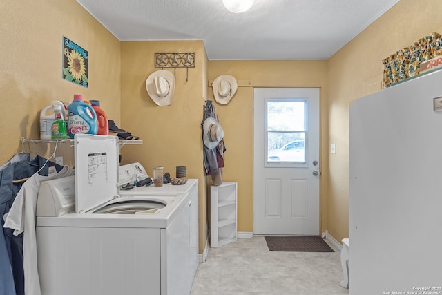 laundry room with washing machine and dryer and light tile floors