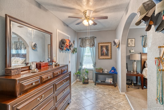 interior space featuring ceiling fan and a textured ceiling