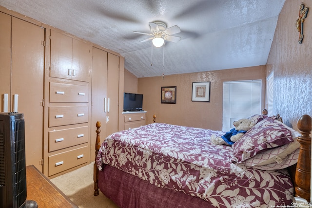 bedroom featuring light colored carpet, vaulted ceiling, ceiling fan, and a textured ceiling