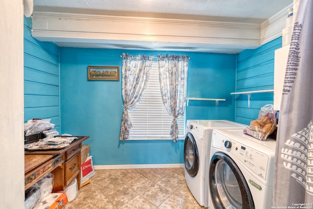 laundry area featuring washing machine and clothes dryer and light tile floors