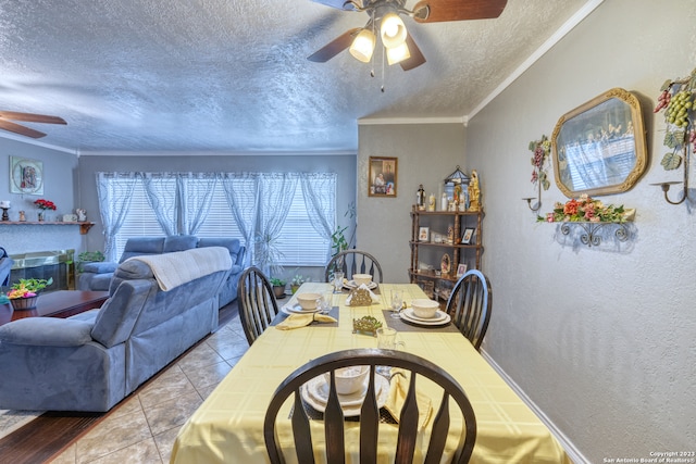 dining area with ornamental molding, a textured ceiling, ceiling fan, and light tile floors