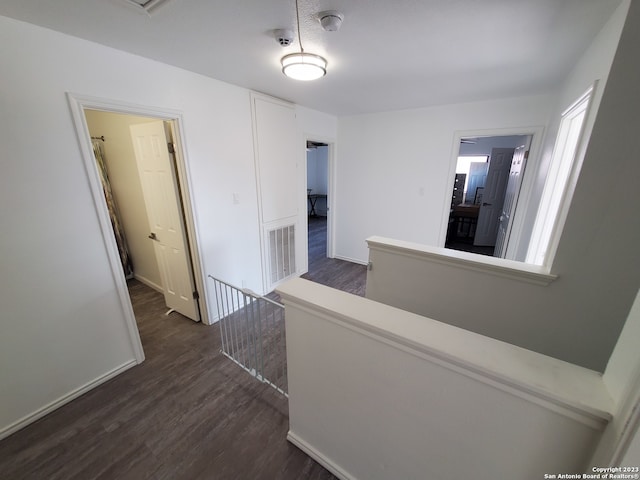 corridor with dark hardwood / wood-style floors