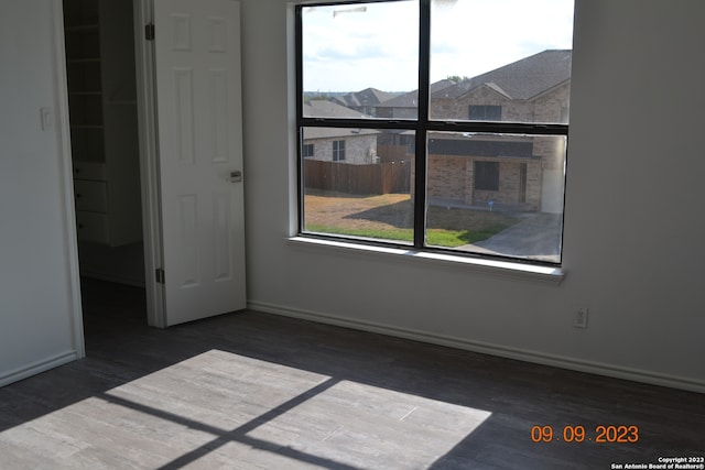 unfurnished room with dark hardwood / wood-style floors