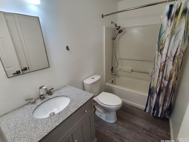 full bathroom with vanity, toilet, shower / bath combo with shower curtain, and hardwood / wood-style flooring