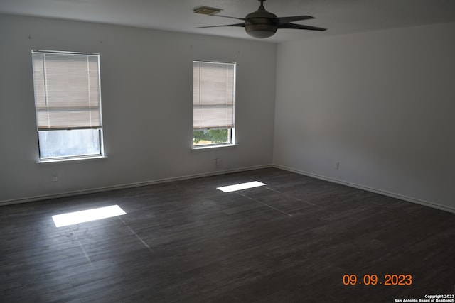 empty room featuring ceiling fan and dark hardwood / wood-style floors