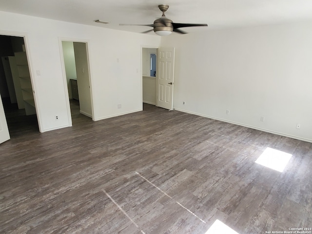 empty room with ceiling fan and dark hardwood / wood-style floors