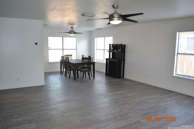 dining area featuring ceiling fan, a textured ceiling, and dark hardwood / wood-style flooring