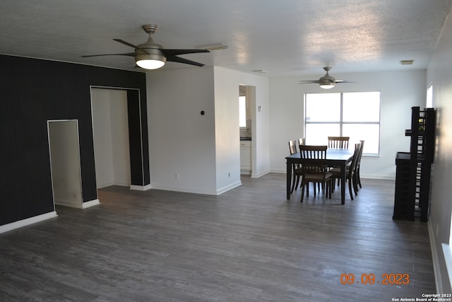 dining area featuring a textured ceiling, ceiling fan, and dark hardwood / wood-style flooring