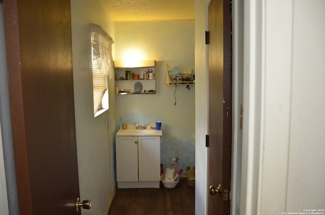 bathroom featuring a textured ceiling, vanity, and wood-type flooring