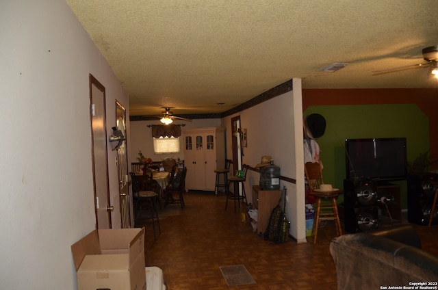 hall with a textured ceiling and dark parquet flooring