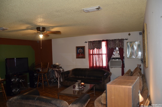 living room with dark parquet floors, a textured ceiling, and ceiling fan