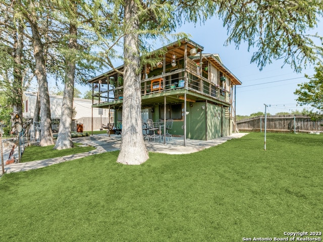 back of property featuring a yard and a patio area