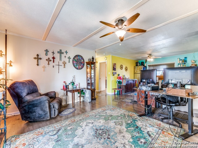 home office featuring dark wood-type flooring and ceiling fan