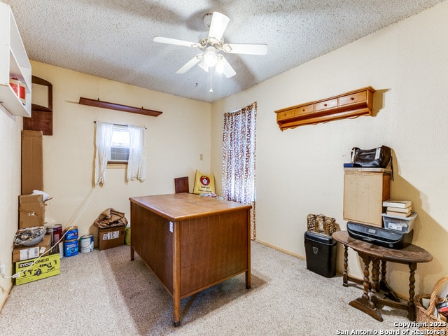 home office with light carpet, a textured ceiling, and ceiling fan