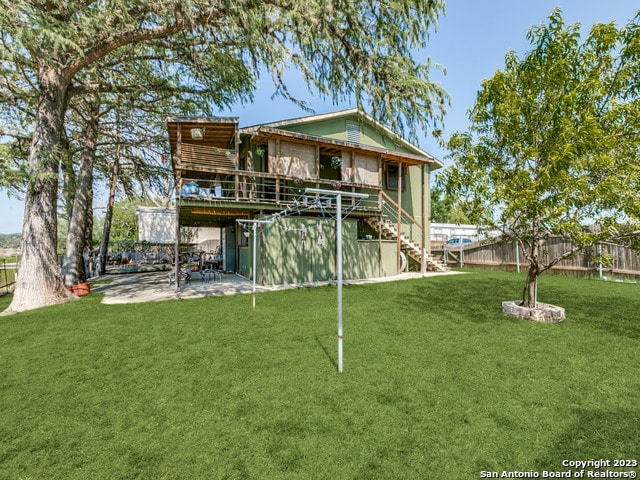 back of property featuring a yard and a patio area