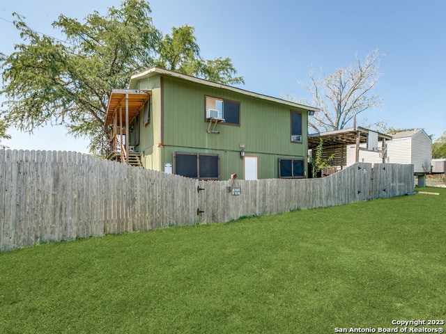 rear view of house with a lawn