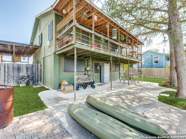 rear view of house featuring a yard and a patio area