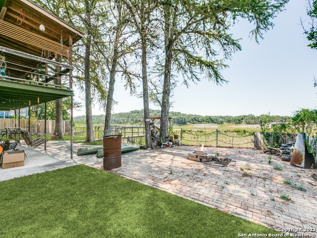 view of yard featuring a patio and a fire pit