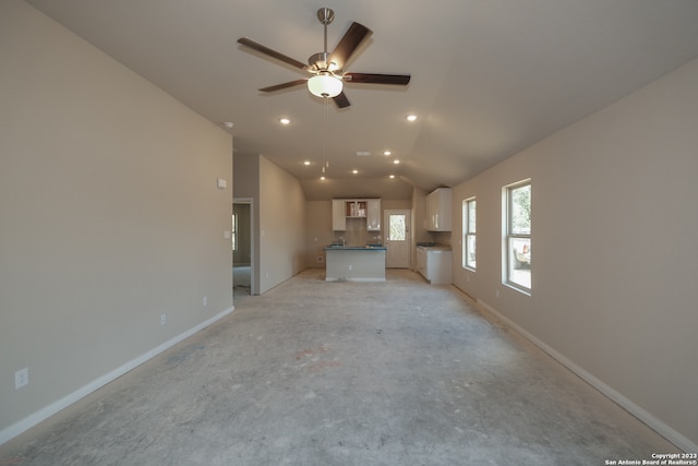 unfurnished living room with vaulted ceiling and ceiling fan