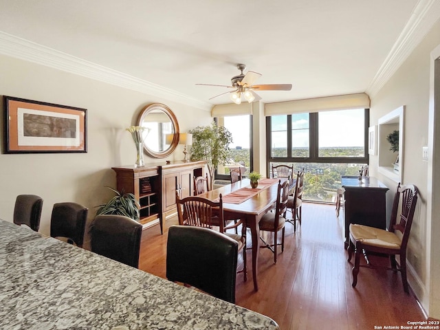 dining area featuring ornamental molding, ceiling fan, and dark wood-type flooring