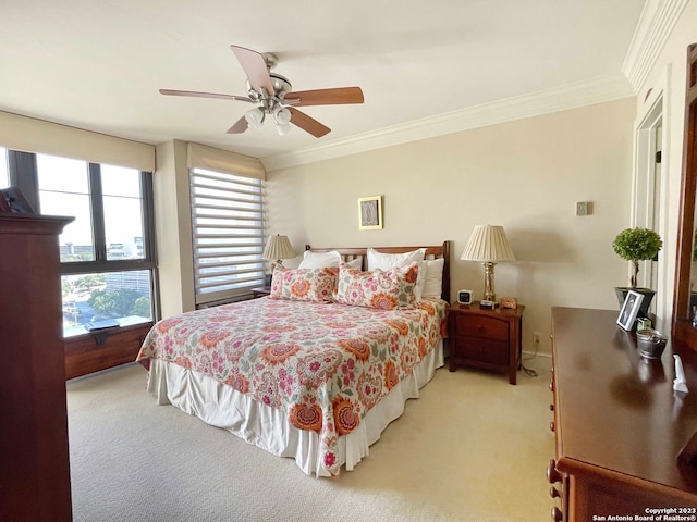 carpeted bedroom featuring ceiling fan and ornamental molding