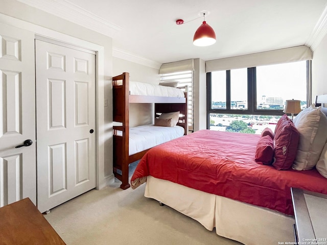 carpeted bedroom featuring ornamental molding