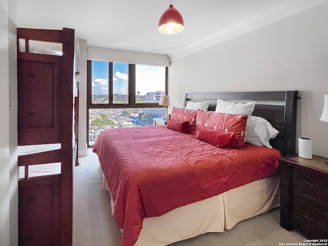 bedroom featuring light carpet, expansive windows, and ornamental molding