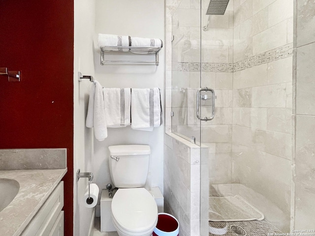 bathroom with an enclosed shower, toilet, and vanity