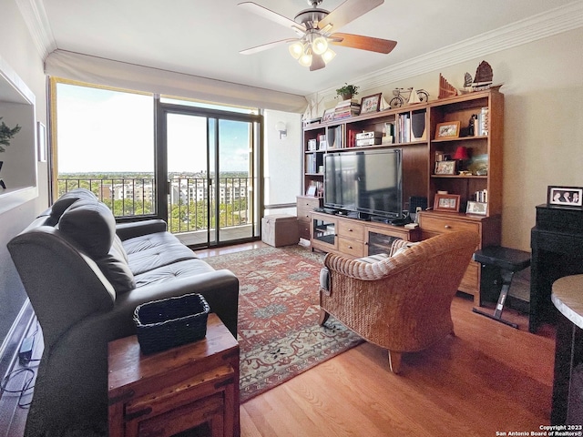 living room with ornamental molding, ceiling fan, and hardwood / wood-style flooring