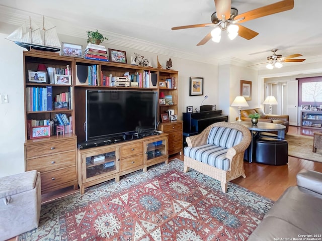 living room featuring ceiling fan, hardwood / wood-style flooring, and crown molding