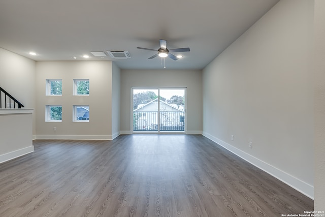 unfurnished living room featuring wood-type flooring and ceiling fan