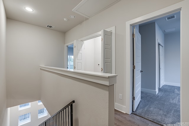 corridor with hardwood / wood-style floors