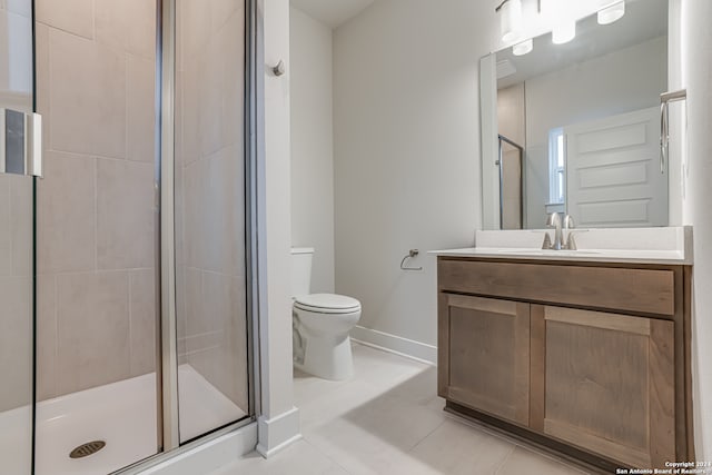 bathroom featuring toilet, vanity, tile patterned floors, and walk in shower